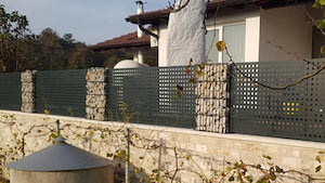 Lochblech Zaun in Moosgrün auf einer Mauer